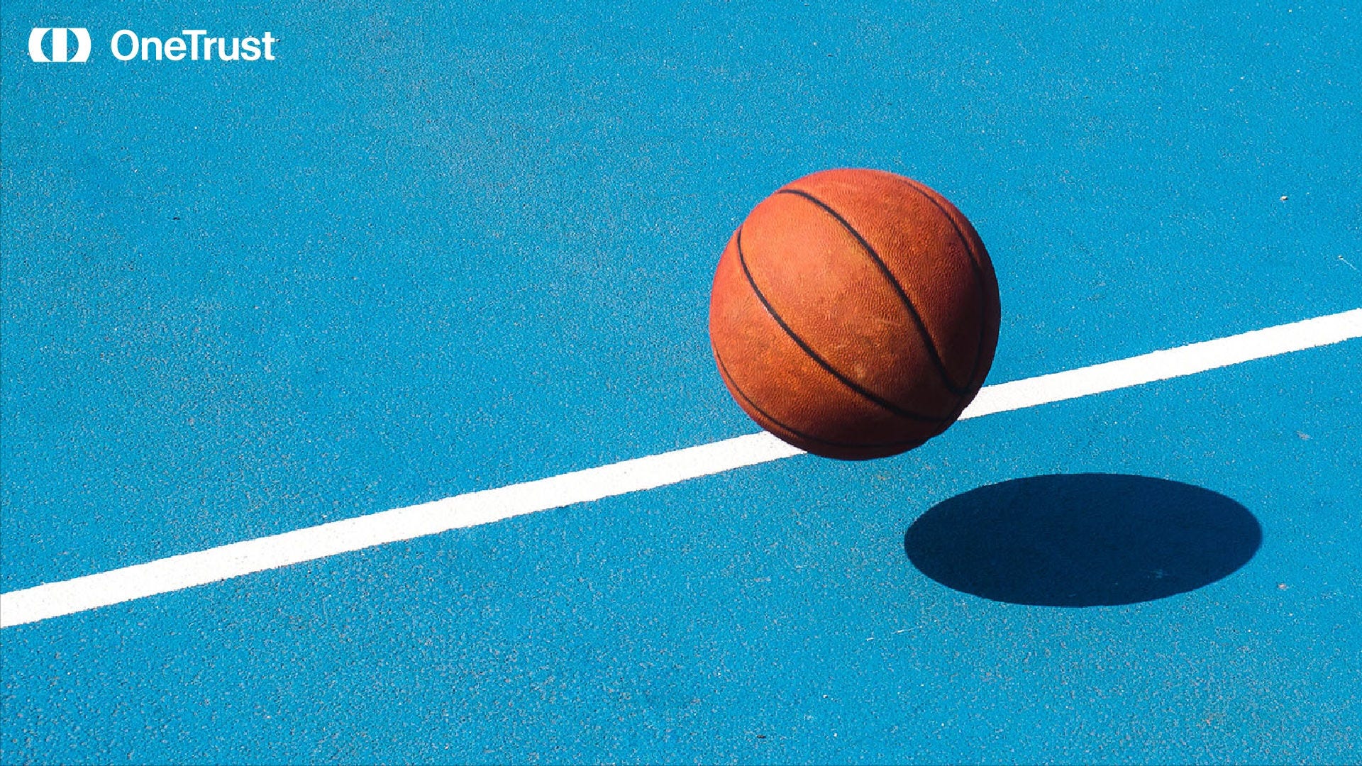 Basketball bouncing on a blue court