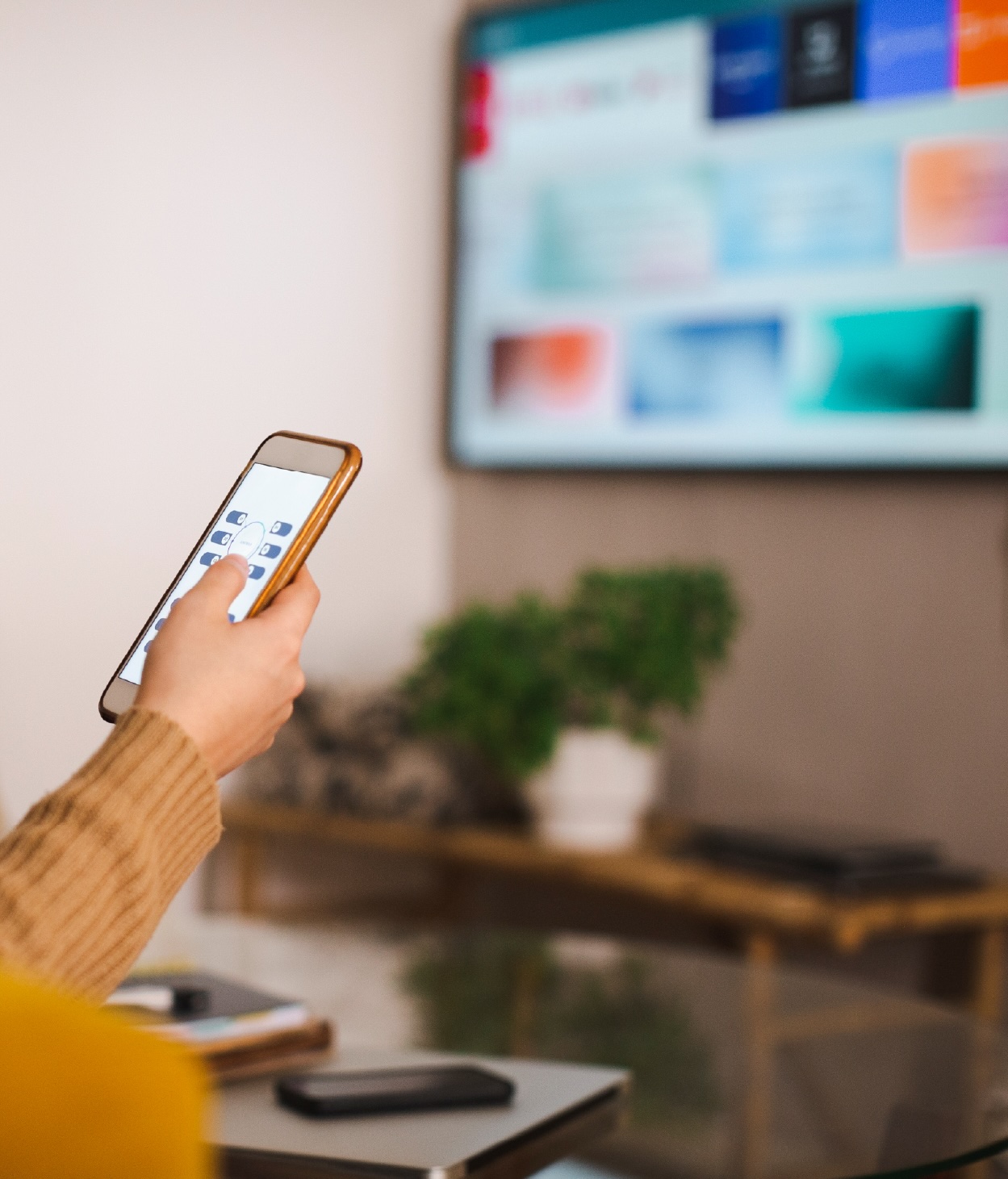 Photo of a television viewer configuring their set's privacy and consent preference center with their mobile phone.